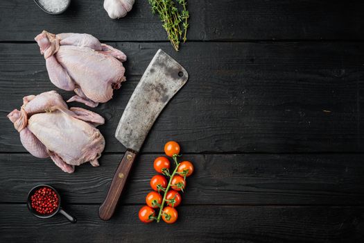 Fresh raw whole chicken carcass with herbs spices, on black wooden table, top view with copy space for text