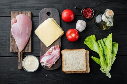 Delicious sandwich with toasted bread ingredient, on black wooden table, top view