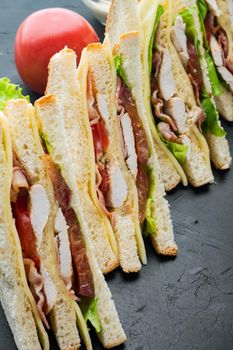Deli fresh sandwich with chicken, on black background