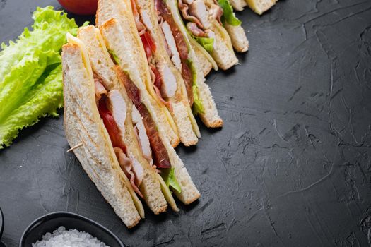 Homemade turkey club sandwich, on black background with copy space for text