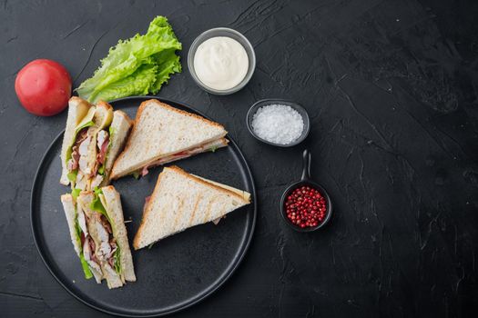 Classic club sandwich with meat, on black background, top view with copy space for text