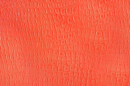 Artificial leather imitation crocodile skin in orange color.Texture or background