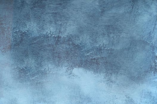 The blue wall is smeared with white paint.Texture or background