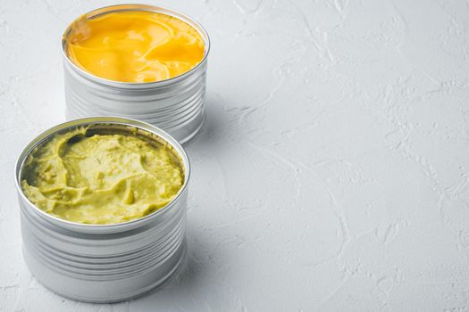 Canned guacamole and cheese dip in can, on white background with copy space for text