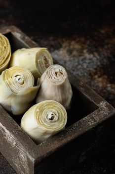 Artichoke hearts marinated with olive oil, on old rustic background