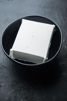 Raw organic white feta cheese set, on black background