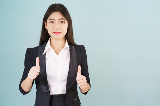 Asian business women in suit and thump up hand sign