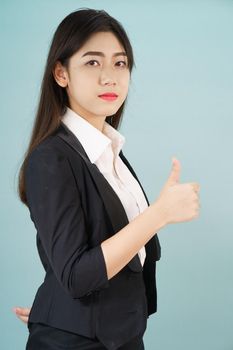 Asian business women in suit and thump up hand sign