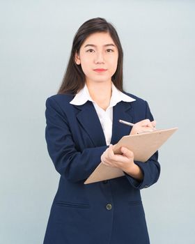 Portrait of Asian woman long hair and wearing suit  with clipboard and pen in hands thinking about success, isolated on white background