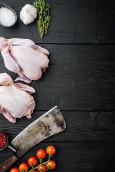 Organic whole fresh poussins with herbs spices, on black wooden table, top view with copy space for text
