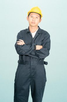 Young man in coveralls helmet hardhat isolated on blue background