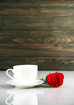 Red roses and coffee cup on table with copy space, Valentine's day concept with red roses