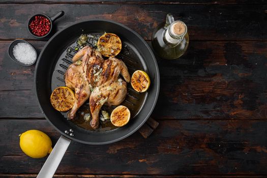 Flattened out whole baked chicken set, on old wooden table, top view with copy space for text