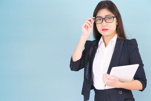 Young women standing in suit holding her digital tablet computor