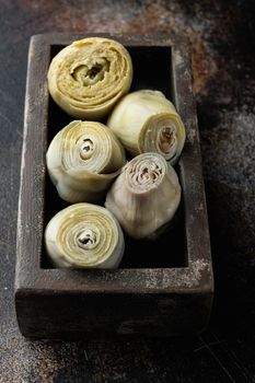 Canned artichokes with olive oil, on old rustic background