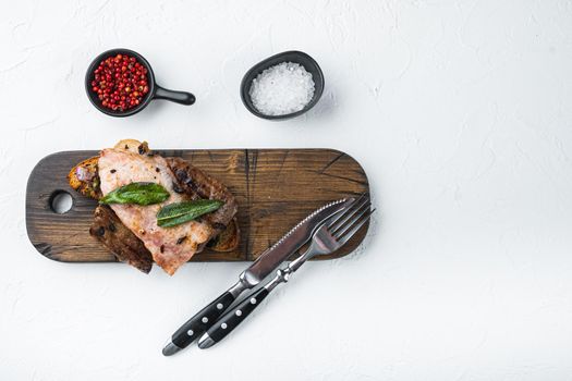 Liver bacon and onions on bread cooked meal served on board, on white background, top view with copy space.