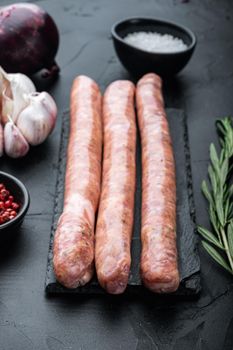 Beef sausages, on black background.