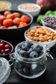 Superfoods dieting clean concept, on black wooden background.