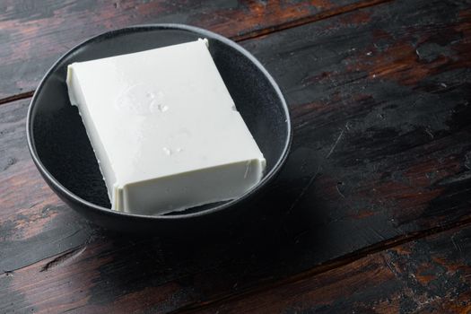 Raw organic white feta cheese set, on old wooden table with copy space for text