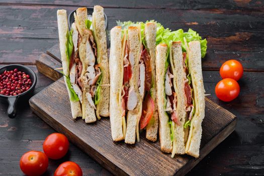 Deli fresh sandwich with chicken, on dark wooden background