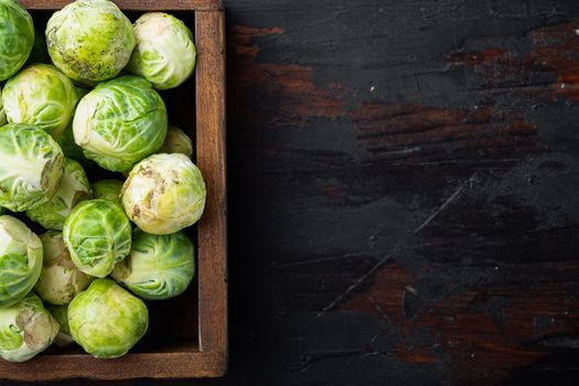 Raw brussels sprouts, on old wooden table, flat lay with space for text