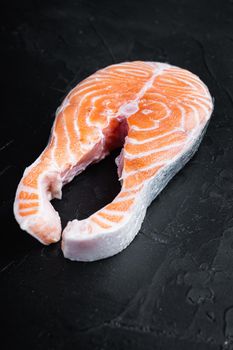Fesh raw trout fillet, over black background.