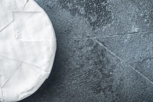 Camembert or brie cheese set, on gray background, top view with copy space for text
