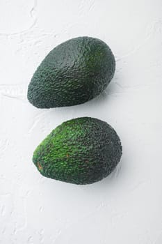 Ripe pair of green avocado set, on white background, top view or flat lay