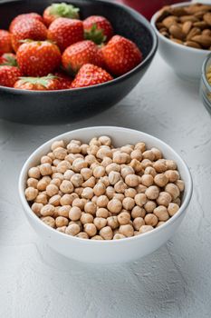 Chickpea in white bowl, on white background.