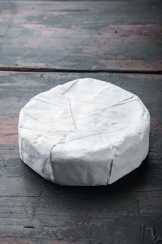 Camembert or brie cheese set, on old wooden table