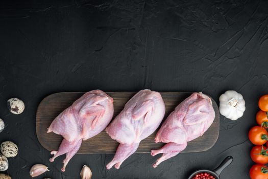 Fresh raw meat quail ready for cooking, flat lay, on black textured background with space for text