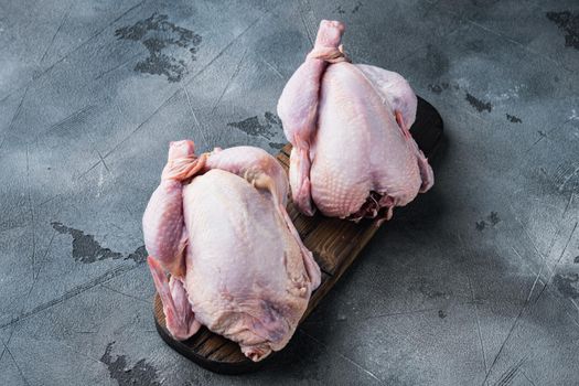 Organic whole fresh poussins, on gray background with copy space for text