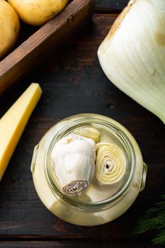 Canned artichokes with olive oil, on old wooden table, flat lay