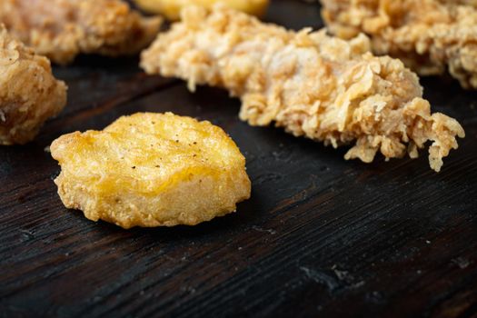 Korean barbeque fried chicken cuts on old dark wooden table, with copy space.