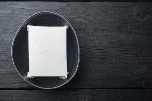 Fresh greek feta cheese set, on black wooden background, flat lay with copy space for text