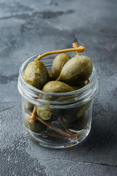 Organic pickled, canned capers, on gray background