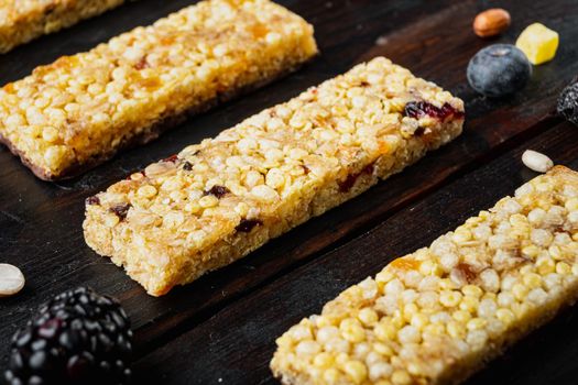 Granola bar with raisins and berry, on wooden table
