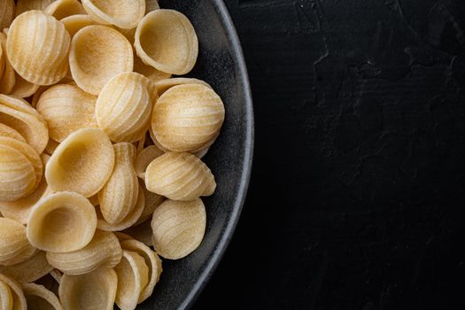 Pasta almentica dried, on black background, top view with copy space for text