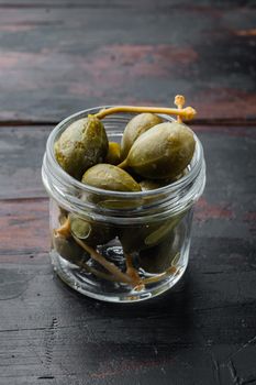 Organic pickled, canned capers, on old wooden table