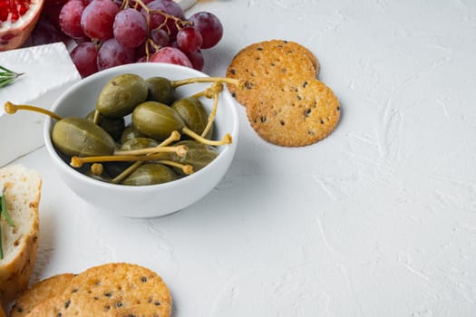 Capers, marinated in oil, on white background with copy space for text