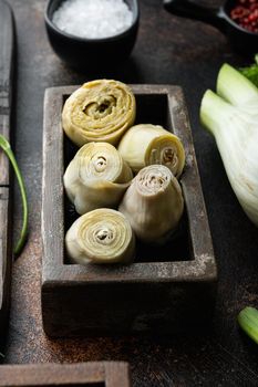 Artichoke hearts marinated with olive oil, on old rustic background
