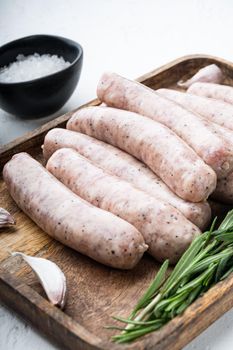 Homemade chicken meat sausages, on white background.