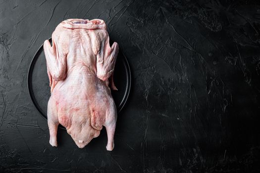 Raw young goose meat on black background, flat lay, with copy space.