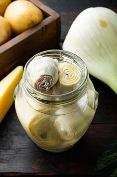Artichoke hearts marinated with olive oil, on old wooden table