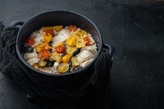 White tilapia fish, with basmati rice and cherry tomatoes, on black background with copy space for text