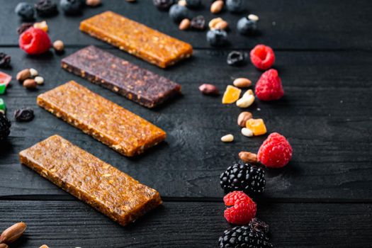 Dried fruits energy bars, on black wooden table