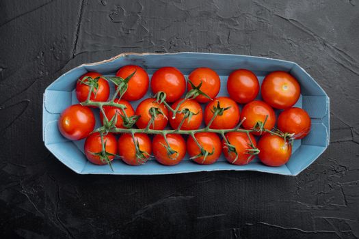 Fresh red organic cherry tomatoes, on black background