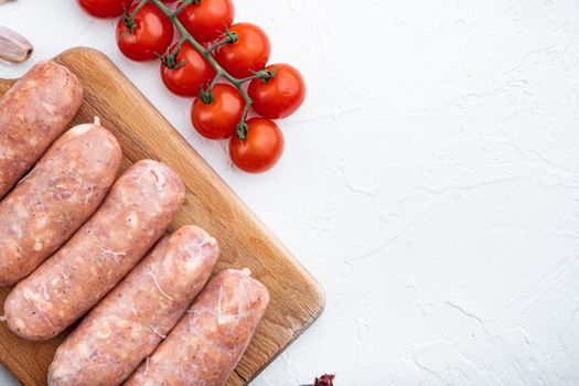 Homemade pork sausages, top view, on white background.