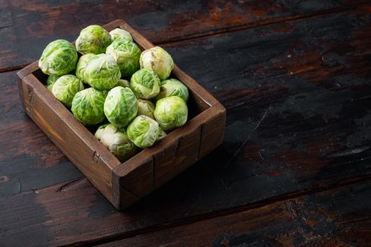 Raw brussels sprouts, on old wooden table with space for text