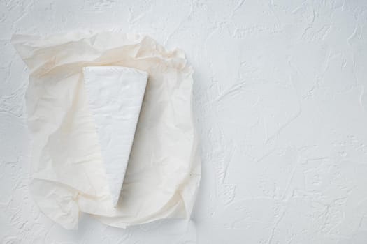 Delicious brie cheese piece, on white background, top view with copy space for text